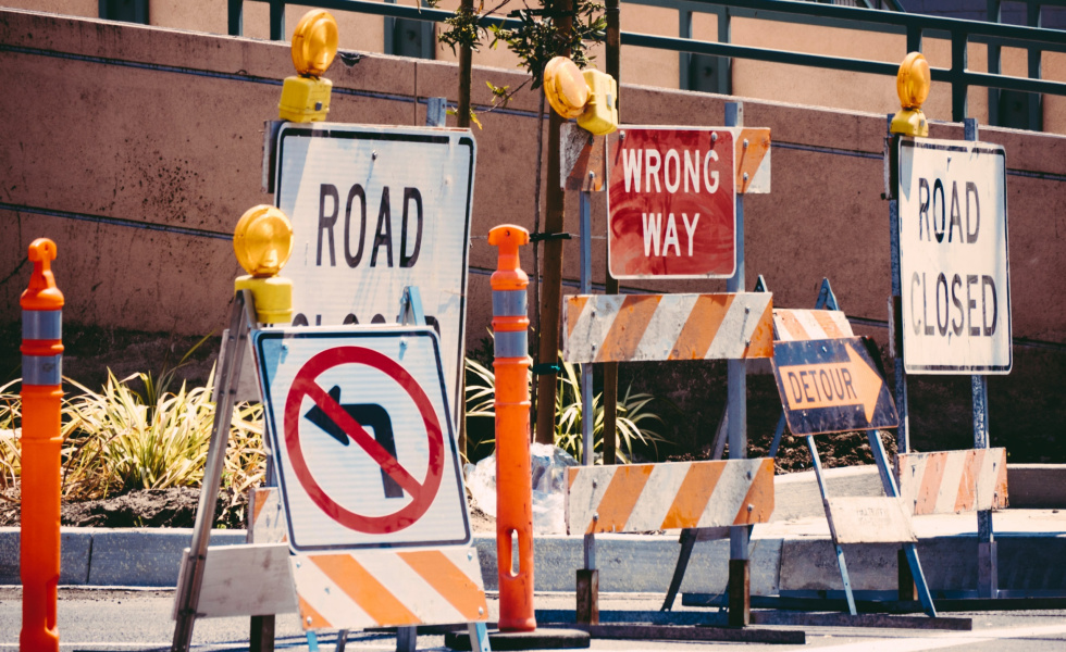 a variety of road block signs on a street