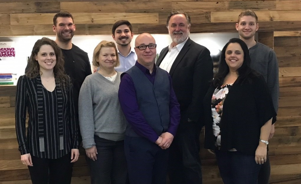 Group of professionals stand together happily after completing training