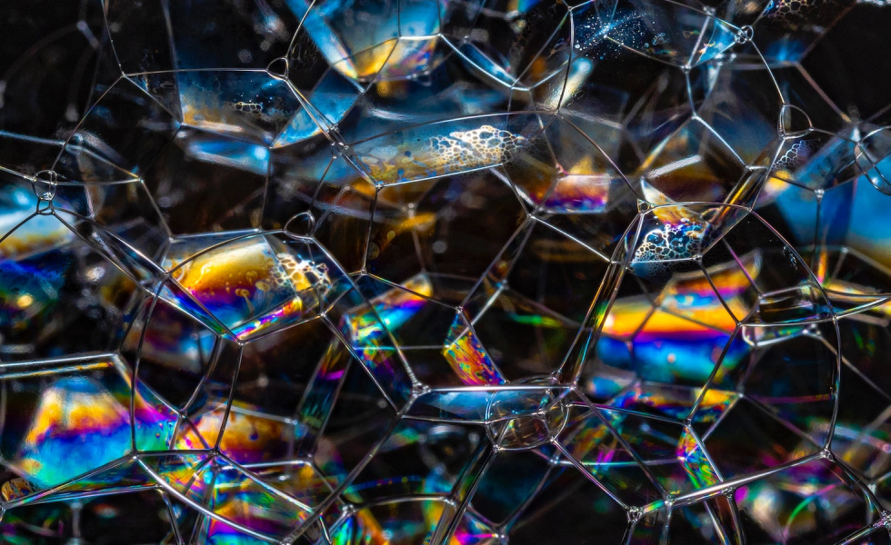 rainbow-colored glass that looks like honeycomb with light hitting different parts